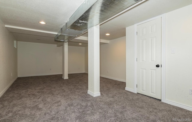 basement with carpet and a textured ceiling