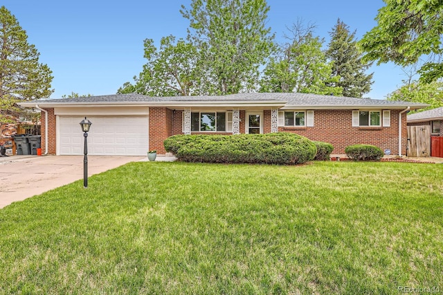 13558 E Center Ave, Aurora, CO 80012 - ranch-style home featuring an attached garage, brick siding, and driveway