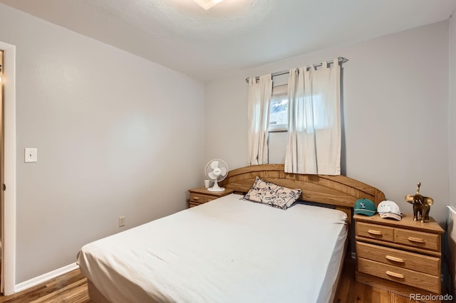 13558 E Center Ave, Aurora, CO 80012 - bedroom with wood finished floors and baseboards