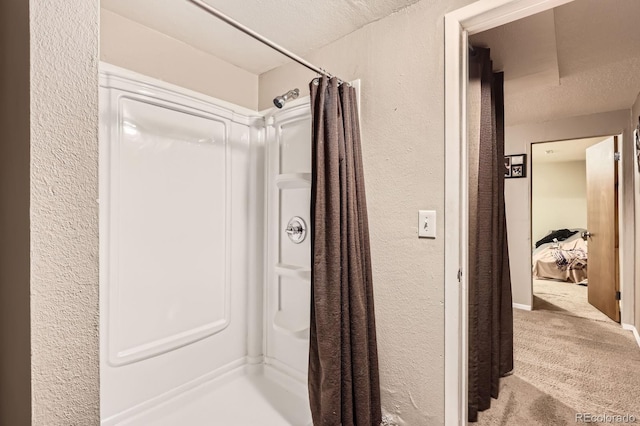 13558 E Center Ave, Aurora, CO 80012 - bathroom with a textured wall and a shower