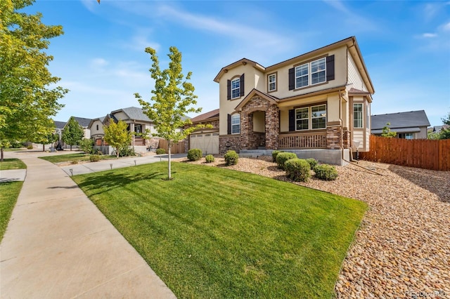 craftsman inspired home with a front lawn, a porch, and a garage