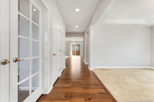 hall with dark hardwood / wood-style floors and french doors