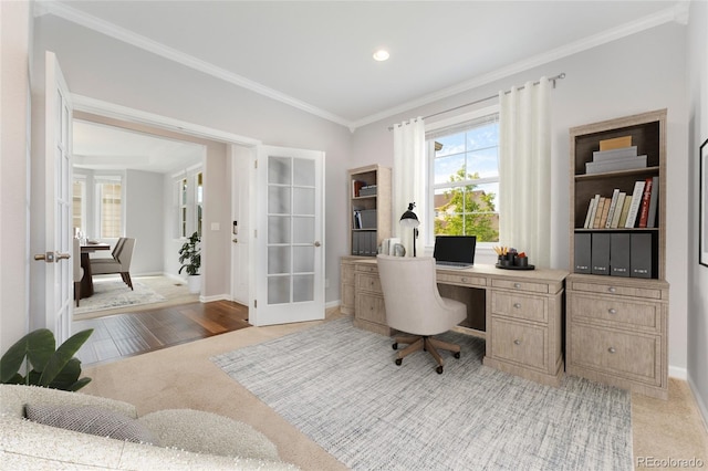 office with crown molding, french doors, and light carpet