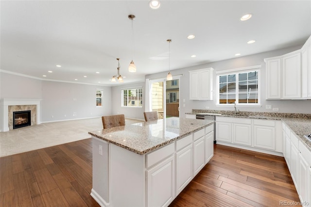 kitchen featuring white cabinetry, a kitchen island, and hanging light fixtures