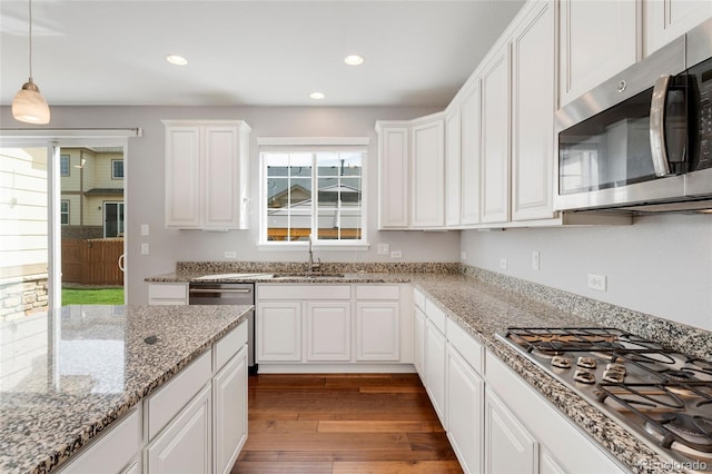 kitchen featuring white cabinetry, sink, and appliances with stainless steel finishes