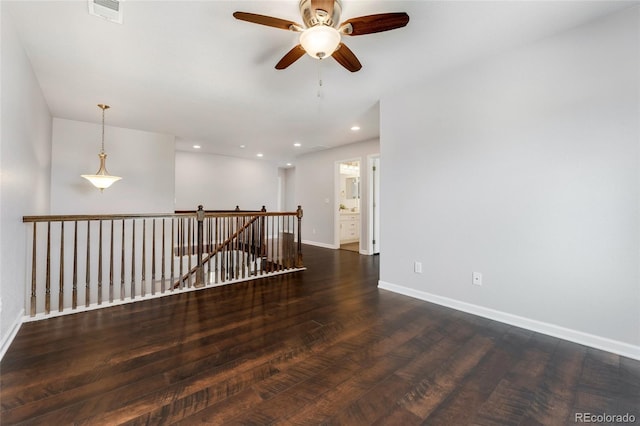 unfurnished room featuring dark hardwood / wood-style flooring and ceiling fan