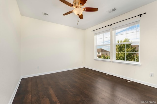 empty room featuring ceiling fan and dark hardwood / wood-style flooring