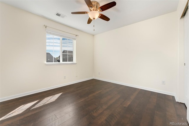 empty room featuring ceiling fan and dark hardwood / wood-style floors