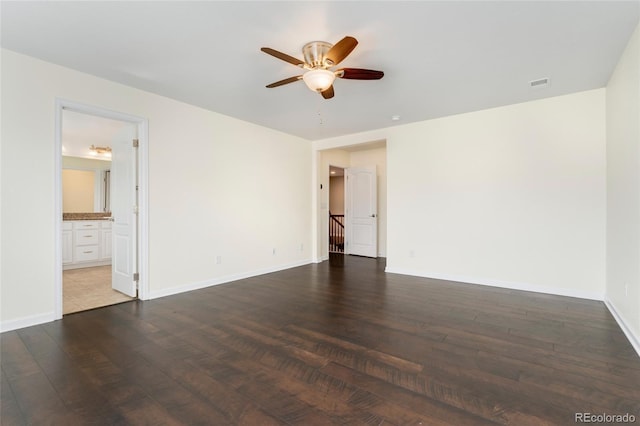 unfurnished bedroom featuring hardwood / wood-style floors, ceiling fan, and connected bathroom