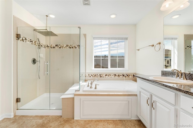 bathroom with tile patterned flooring, vanity, and independent shower and bath