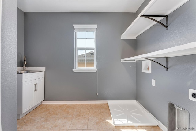 washroom featuring cabinets, washer hookup, electric dryer hookup, sink, and light tile patterned flooring