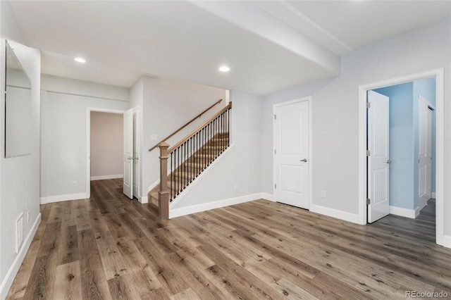 unfurnished room with dark hardwood / wood-style flooring