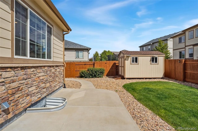 view of yard featuring a storage unit and a patio area