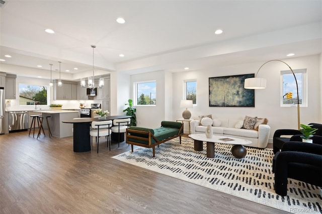 8410 W 52nd Ave, Arvada, CO 80002 - living room featuring wood finished floors, a chandelier, and recessed lighting