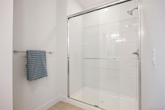 8410 W 52nd Ave, Arvada, CO 80002 - bathroom featuring a shower stall, tile patterned floors, and baseboards