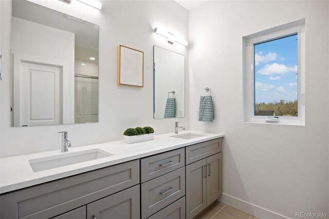 8410 W 52nd Ave, Arvada, CO 80002 - full bath featuring double vanity, baseboards, a shower with door, and tile patterned flooring