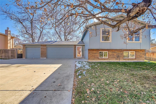 tri-level home with a front lawn and a garage