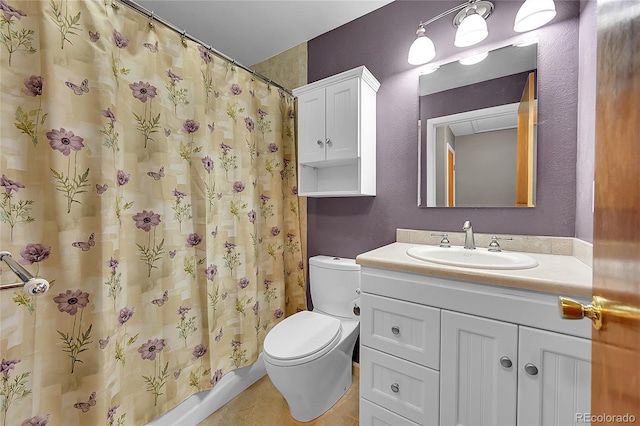 bathroom featuring tile patterned flooring, vanity, curtained shower, and toilet