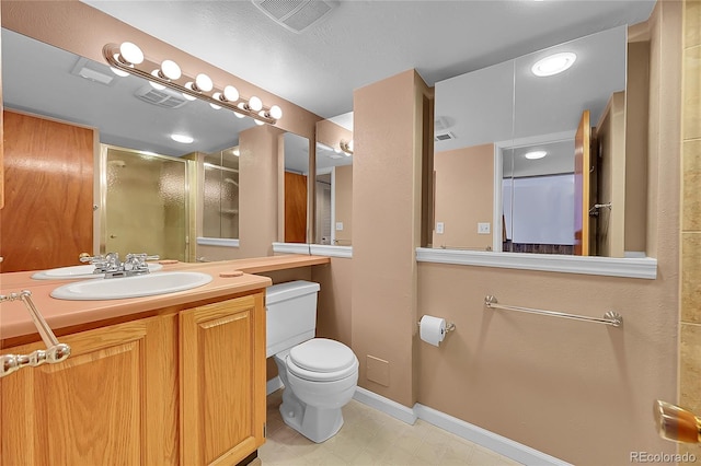 bathroom featuring vanity, toilet, and walk in shower