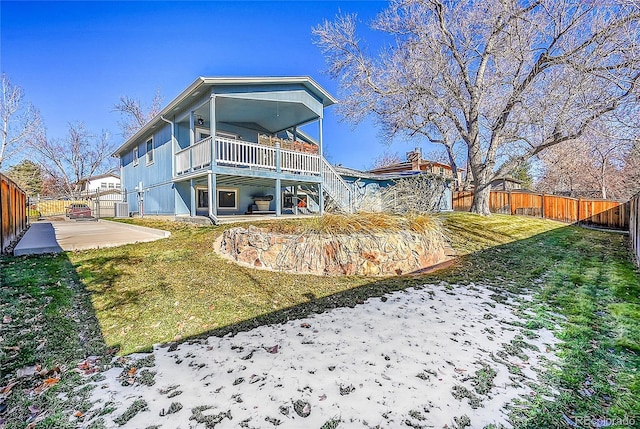 rear view of house with a lawn and a patio area