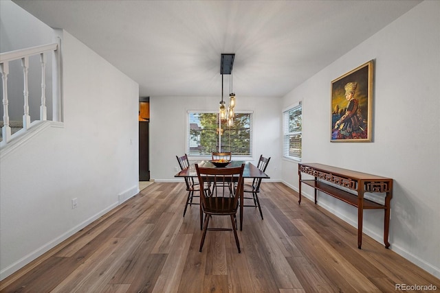 dining room featuring wood-type flooring and a chandelier