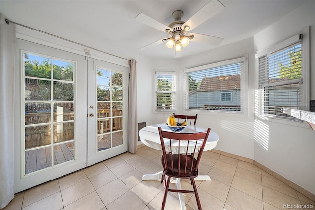 sunroom / solarium featuring french doors and ceiling fan