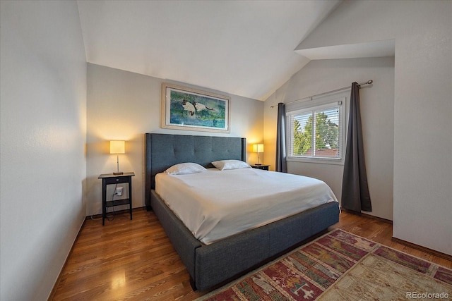 bedroom featuring lofted ceiling and wood-type flooring