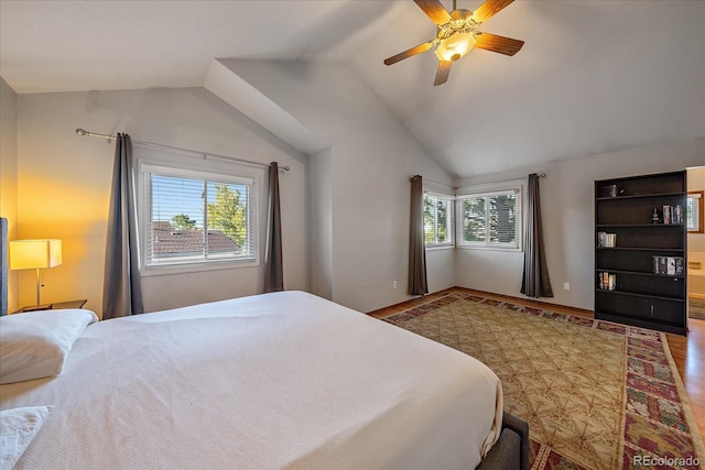 bedroom featuring hardwood / wood-style floors, ceiling fan, and vaulted ceiling