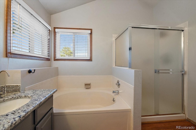 bathroom with vaulted ceiling, plus walk in shower, vanity, and wood-type flooring