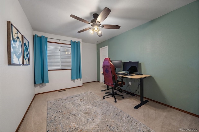 carpeted office space with ceiling fan