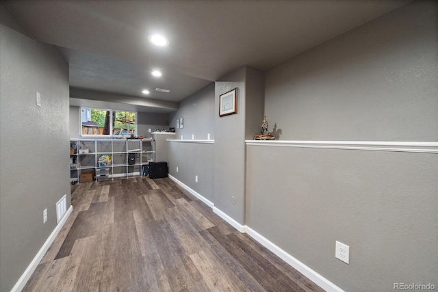 basement with hardwood / wood-style flooring