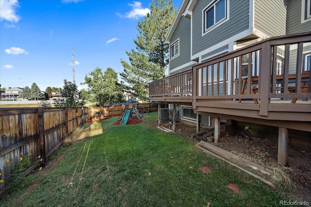 view of yard with a wooden deck and a playground