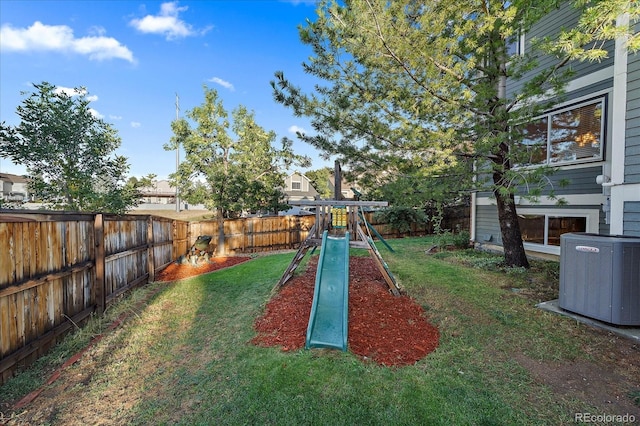 view of yard featuring a playground and central air condition unit