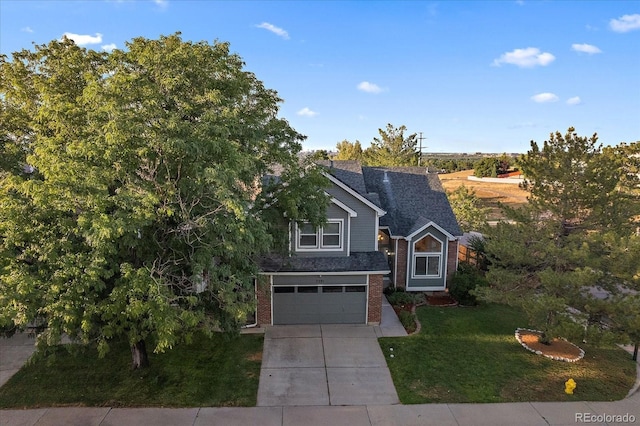 view of front of property with a front yard and a garage