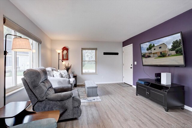 1769 S Lee St Unit B, Lakewood, CO 80232 - living area with healthy amount of natural light, wood finished floors, and baseboards