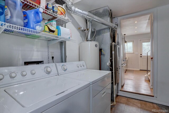 1769 S Lee St Unit B, Lakewood, CO 80232 - laundry room with water heater, washing machine and dryer, baseboards, recessed lighting, and tile patterned flooring