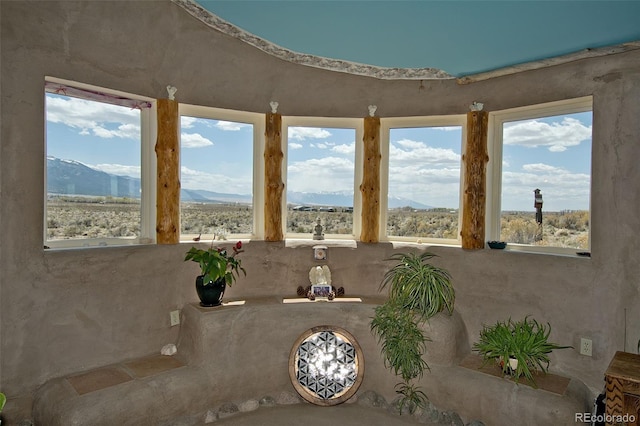 unfurnished sunroom with a mountain view