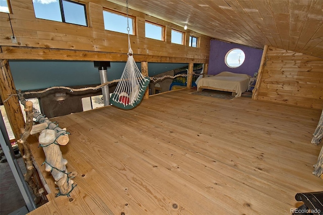 unfurnished bedroom featuring wooden ceiling, wooden walls, and vaulted ceiling