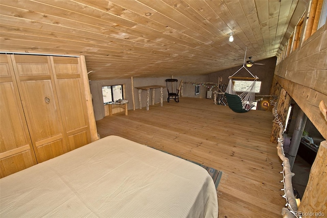 unfurnished bedroom with a fireplace, hardwood / wood-style floors, and wooden ceiling