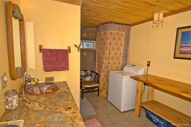 laundry area featuring washer / clothes dryer, sink, light tile patterned floors, and wood ceiling