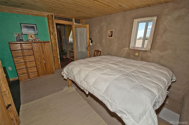 bedroom with carpet flooring and wooden ceiling