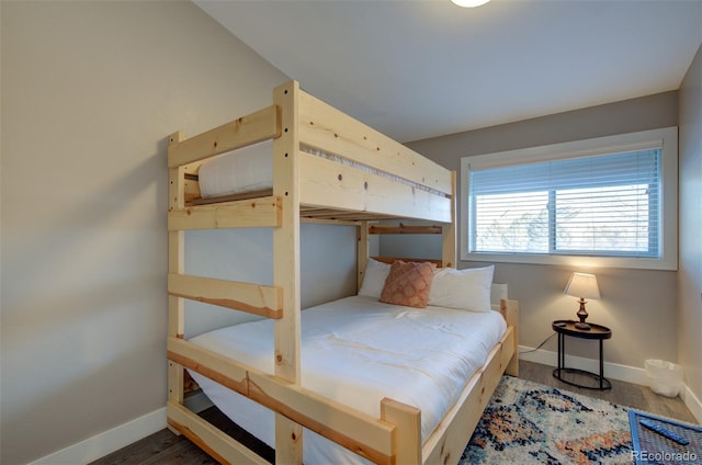 bedroom featuring wood finished floors and baseboards