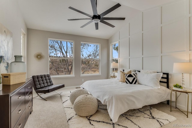 carpeted bedroom with ceiling fan and lofted ceiling