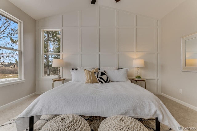 carpeted bedroom featuring lofted ceiling, ceiling fan, and multiple windows