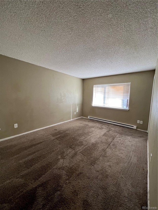 carpeted spare room featuring a textured ceiling and a baseboard radiator