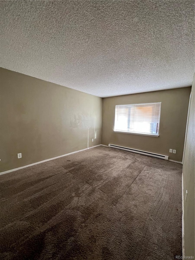 3658 S Norfolk Way, Aurora, CO 80013 - spare room featuring a baseboard heating unit, carpet flooring, and a textured ceiling