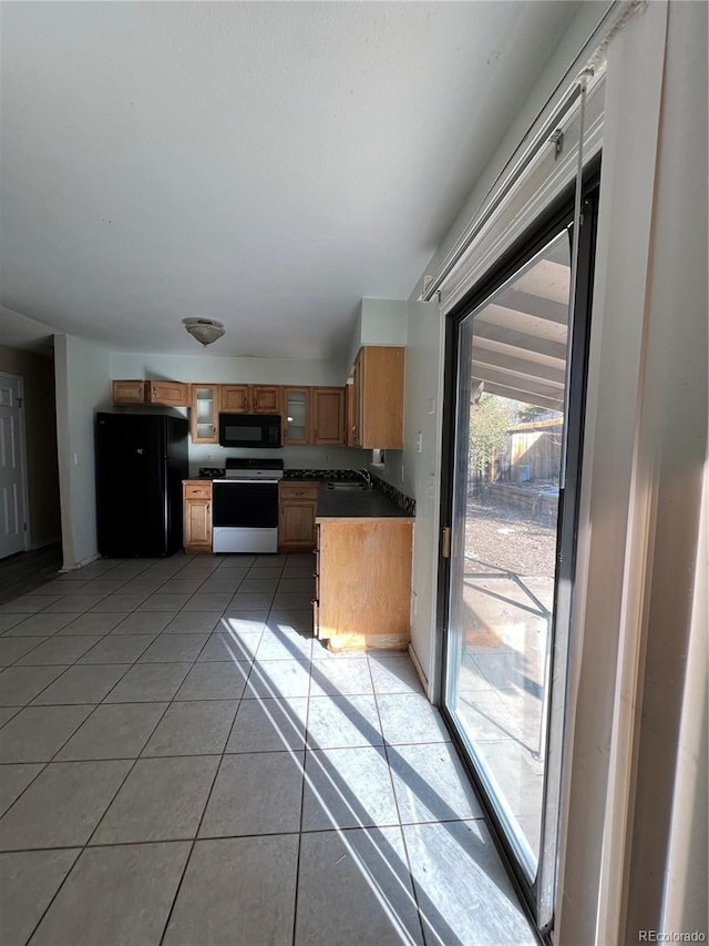 kitchen featuring light tile patterned floors and black appliances