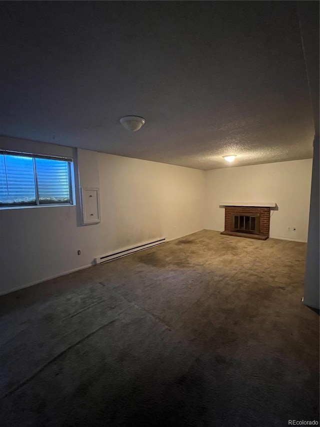 basement with carpet flooring, a baseboard radiator, a brick fireplace, electric panel, and a textured ceiling