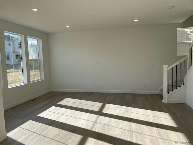 empty room with dark wood-type flooring