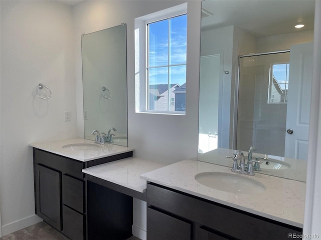 bathroom featuring an enclosed shower, vanity, and a wealth of natural light